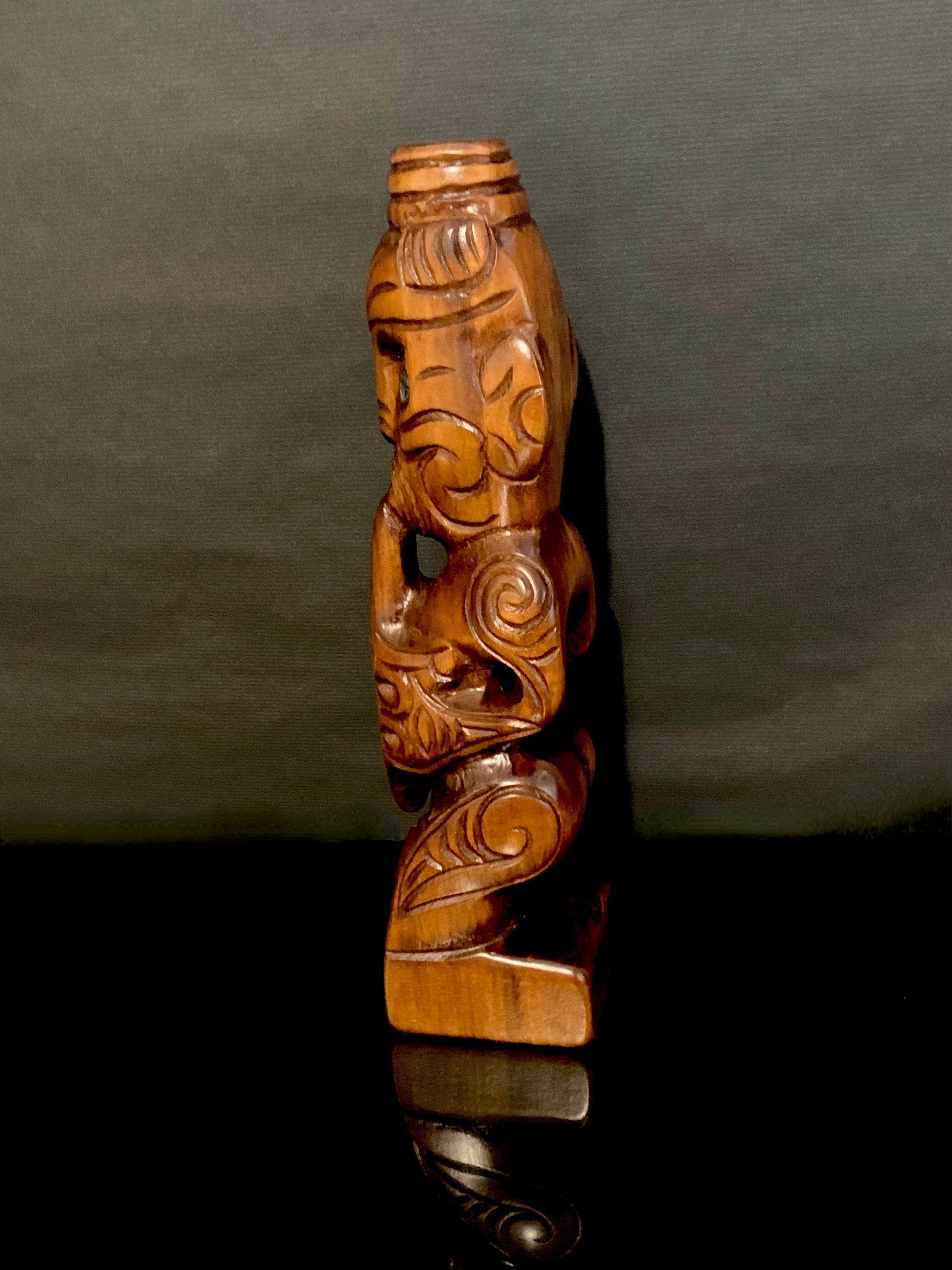side view facing left of New Zealand Maori teko teko carved by Wood Masters Silver Fern Gallery