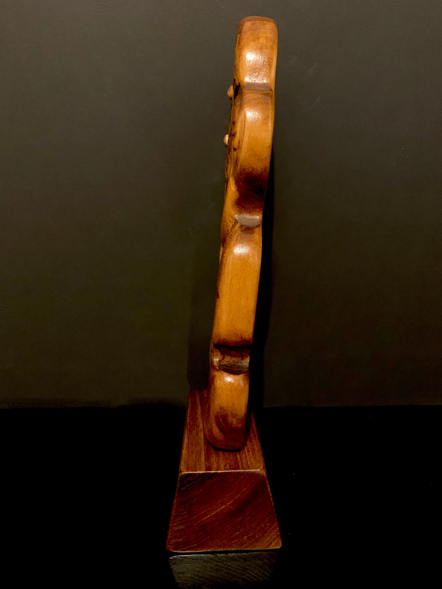 side view of Maori small koru on stand carved in New Zealand and available from Silver Fern Gallery