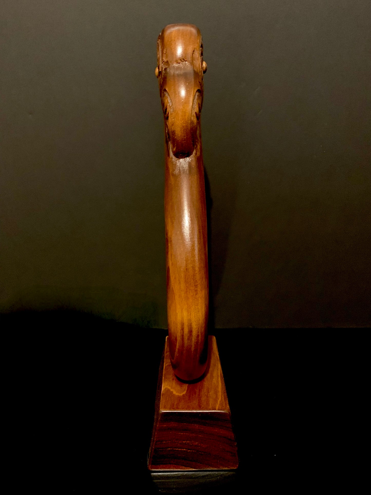 side view of matau fish hook on base by Wood Masters available from Silver Fern Gallery