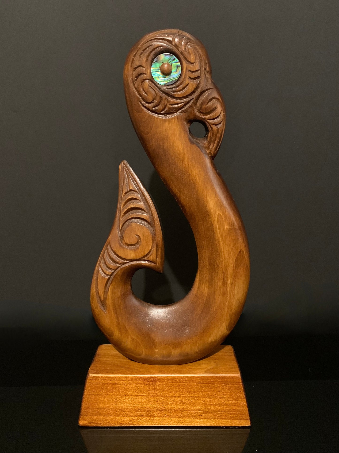 reverse of matau fish hook on base by Wood Masters available from Silver Fern Gallery