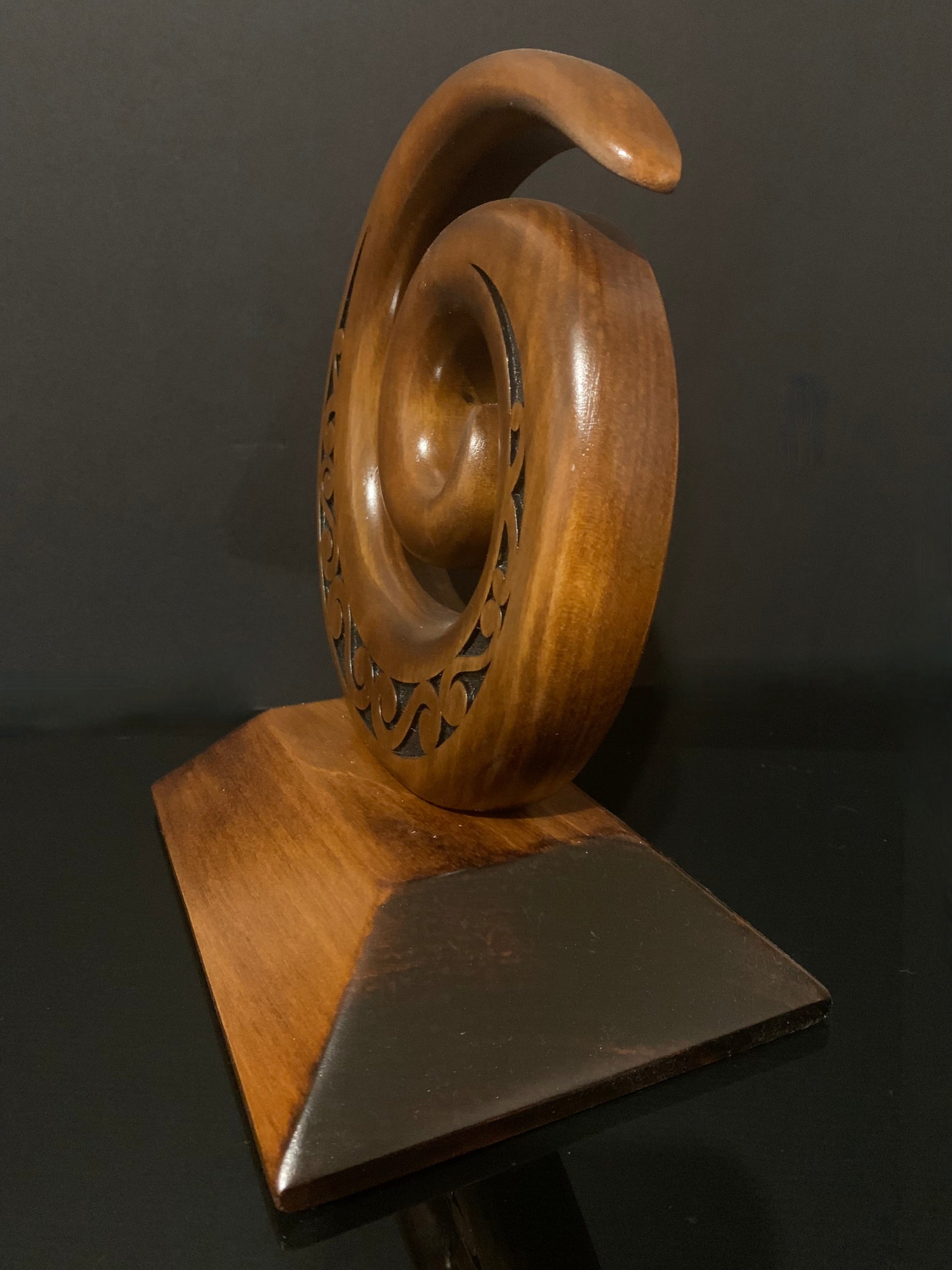 side view of Koru carved in New Zealand and available from Silver Fern Gallery
