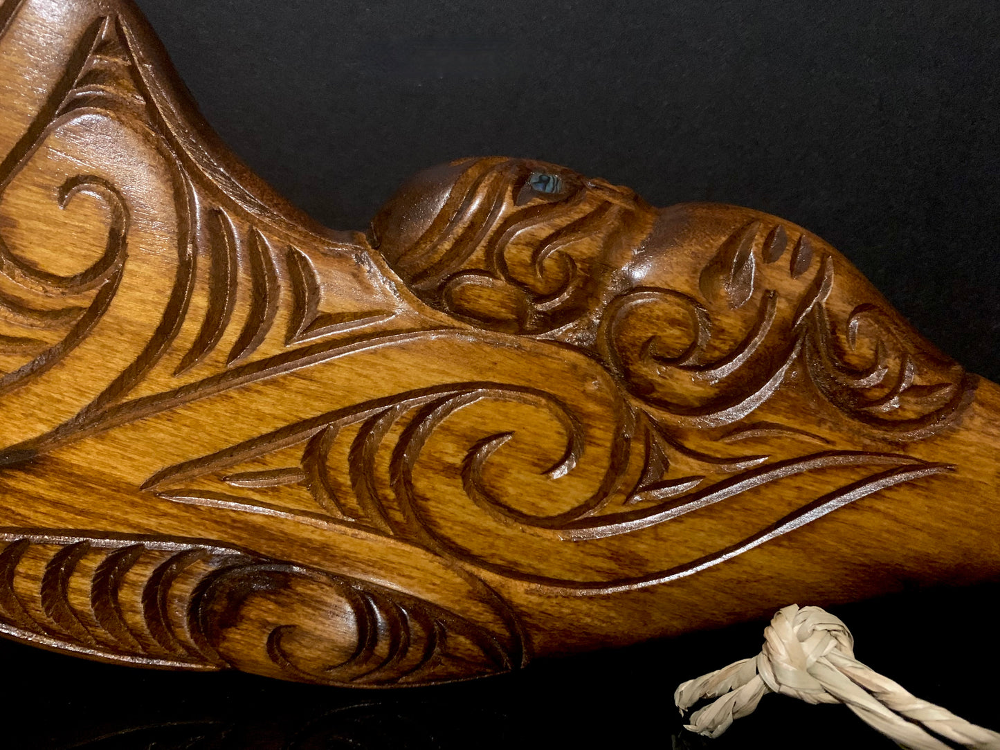 close up of detail on Maori wood wahaika weapon carved in New Zealand and available from Silver Fern Gallery