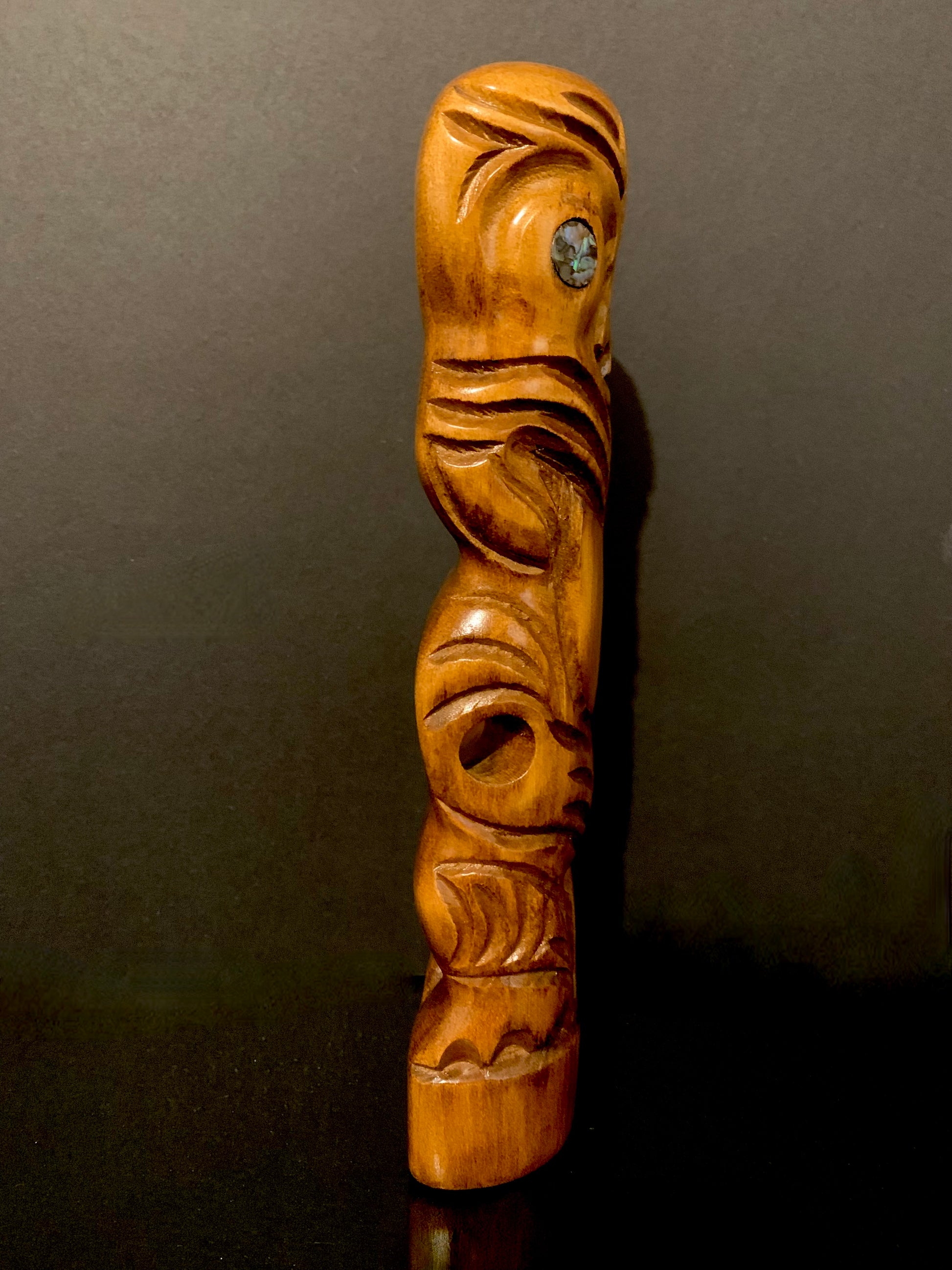 view of Maori teko teko statue looking right
