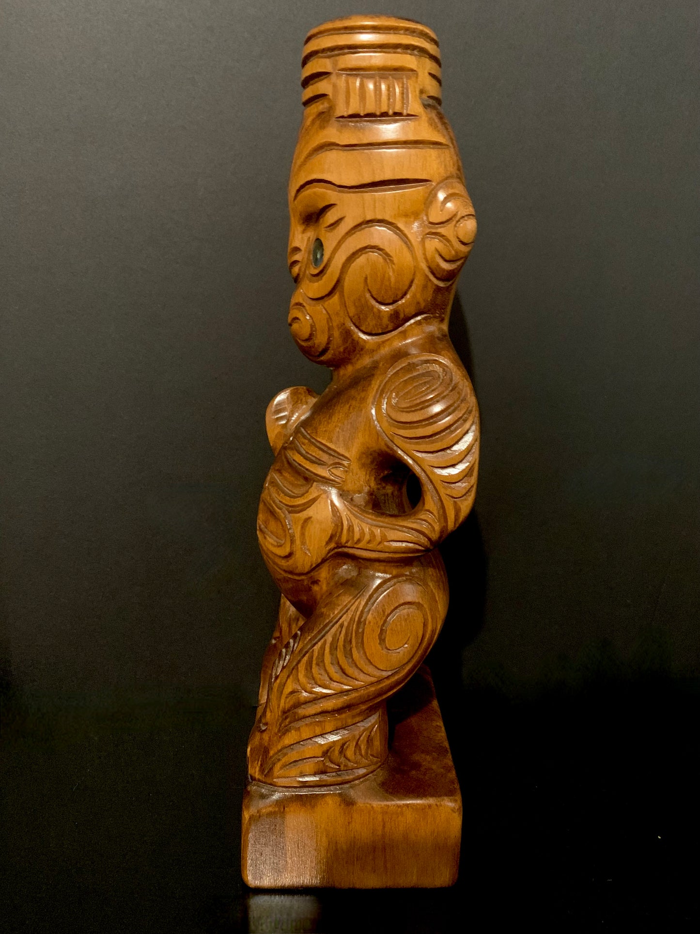 left side view of Maori teko teko with patu carved in New Zealand by Wood Masters available from Silver Fern Gallery