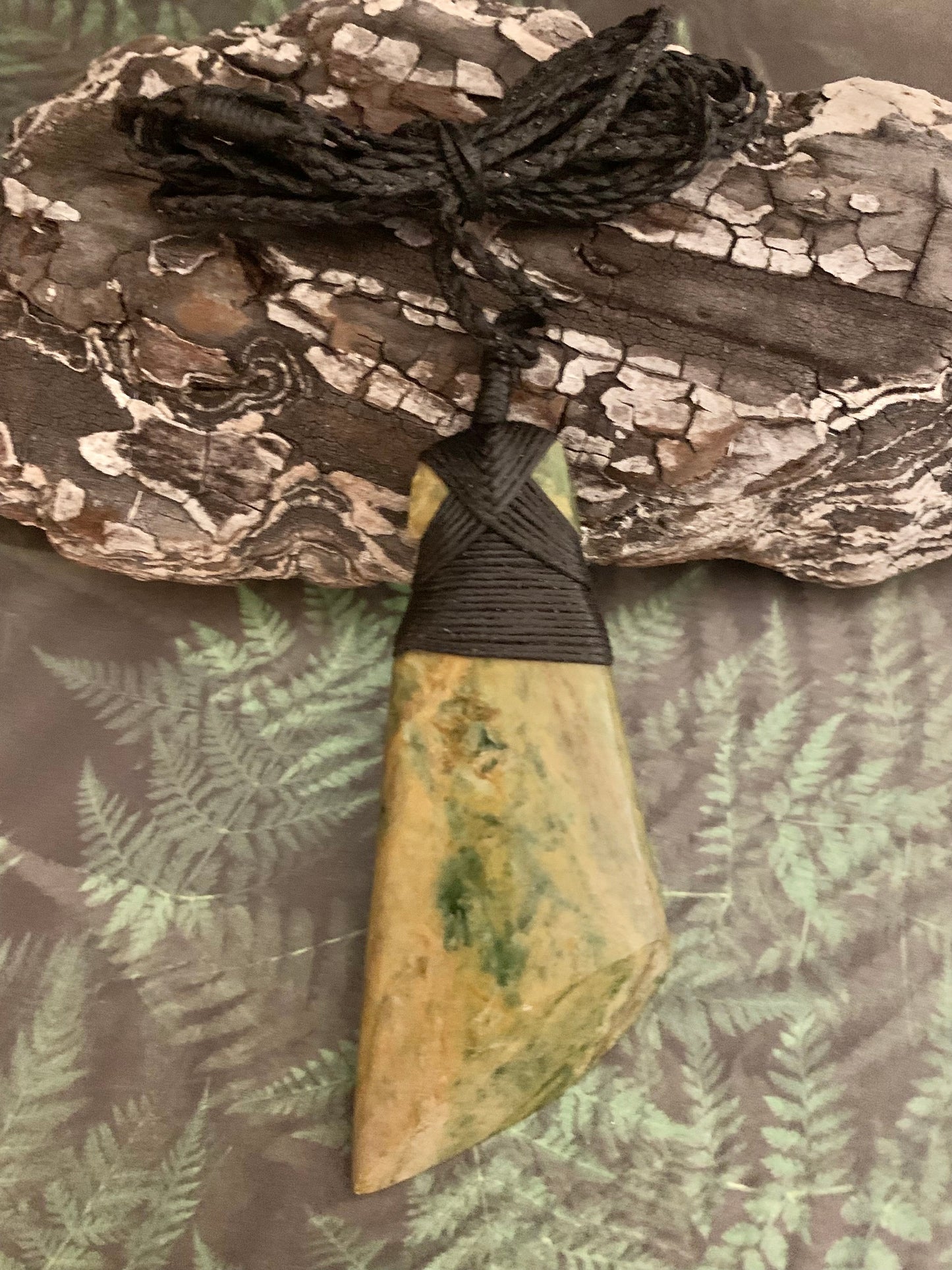 front view of Maori Pounamu hei toki pendant from New Zealand available to purchase