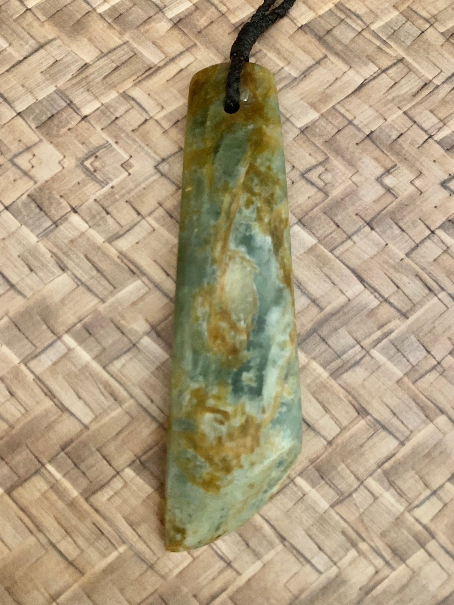 front view of Maori Pounamu hei toki pendant from New Zealand available to purchase