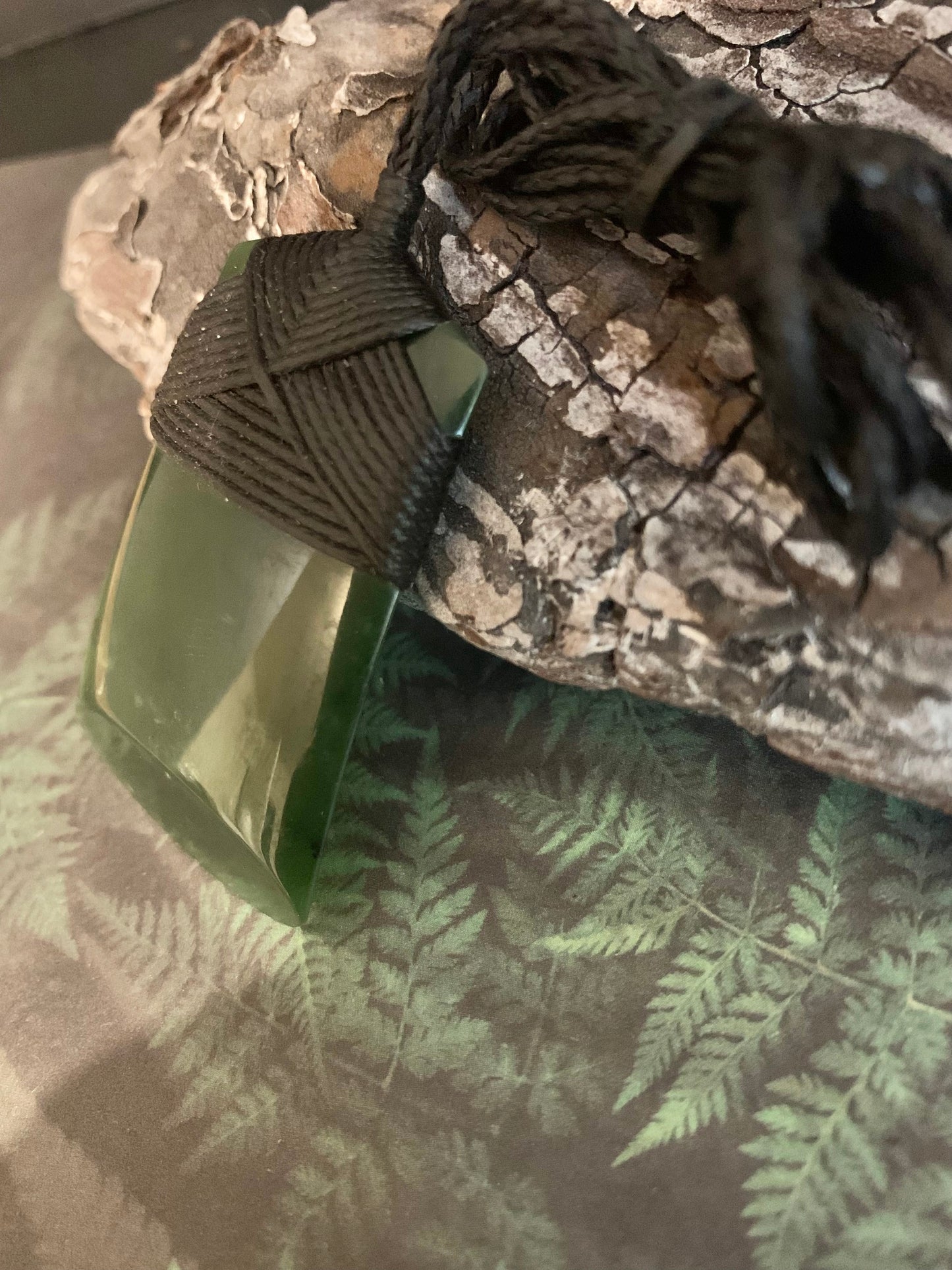 side view of Maori Pounamu hei toki adornment from New Zealand available at Silver Fern Gallery