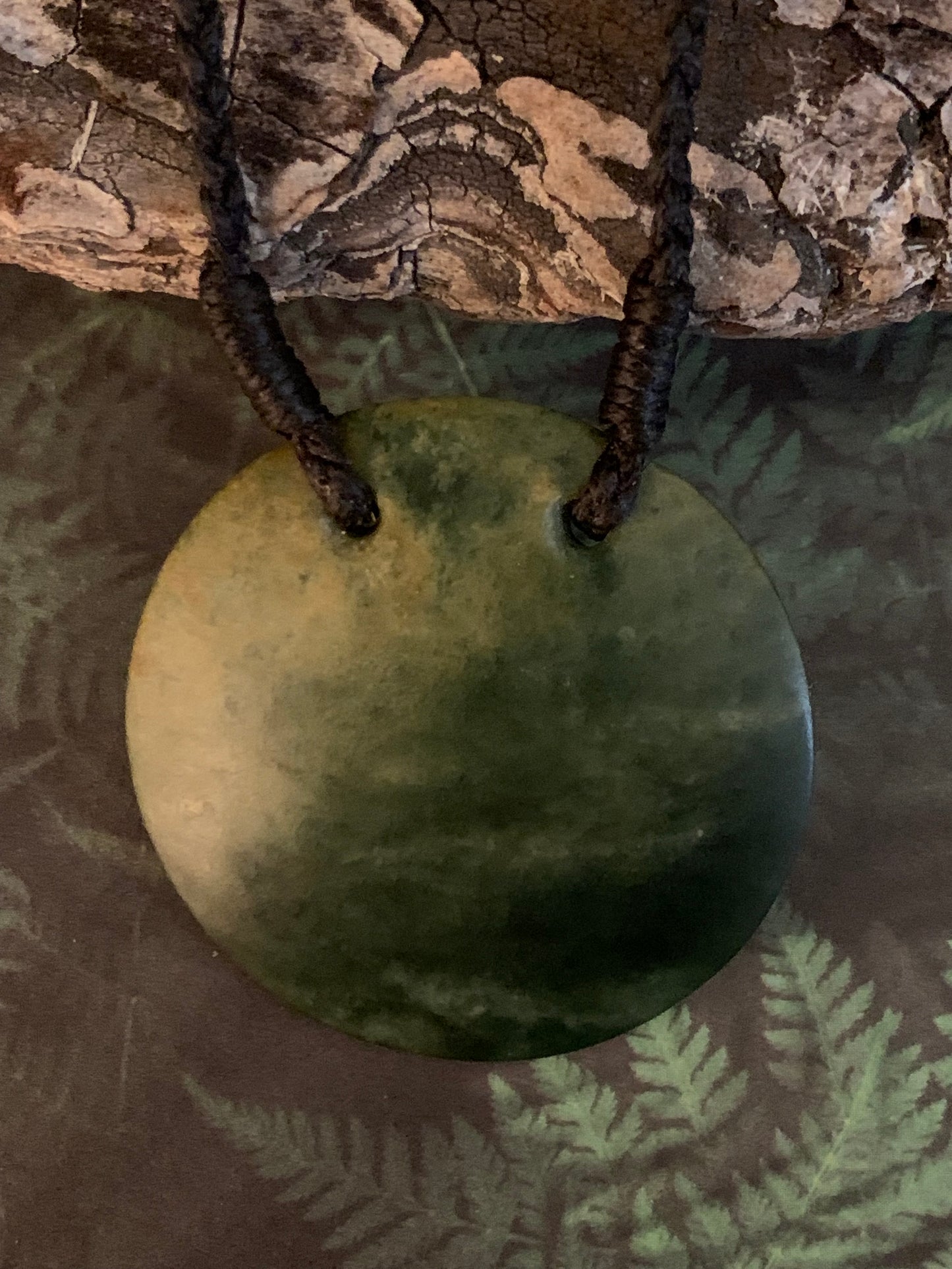 Maori Pounamu porohita disc adornment from New Zealand available at Silver Fern Gallery