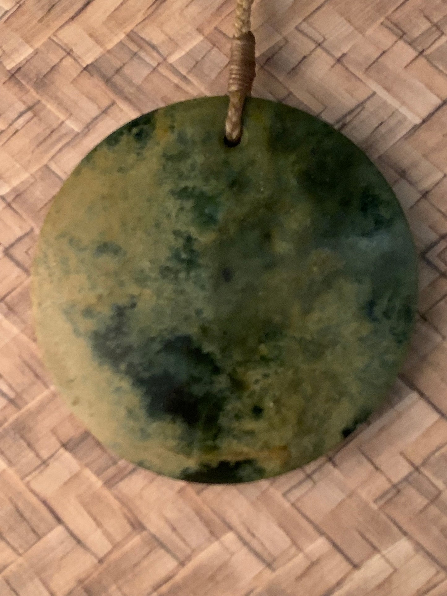 showing one side of Maori made Porohita Disc from New Zealand