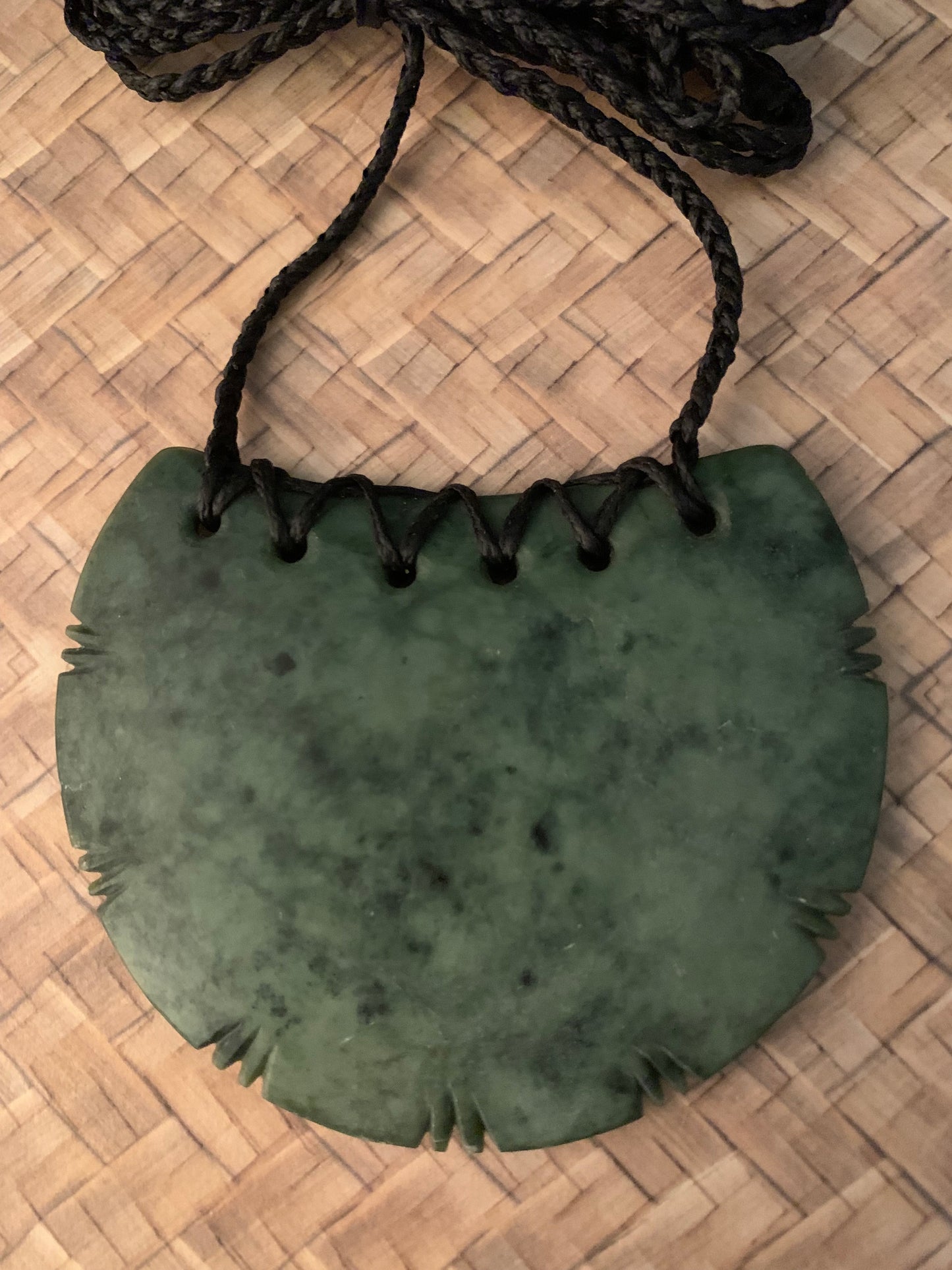 Maori Pounamu wahine breast plate with geneology knotches adornment from New Zealand available at Silver Fern Gallery