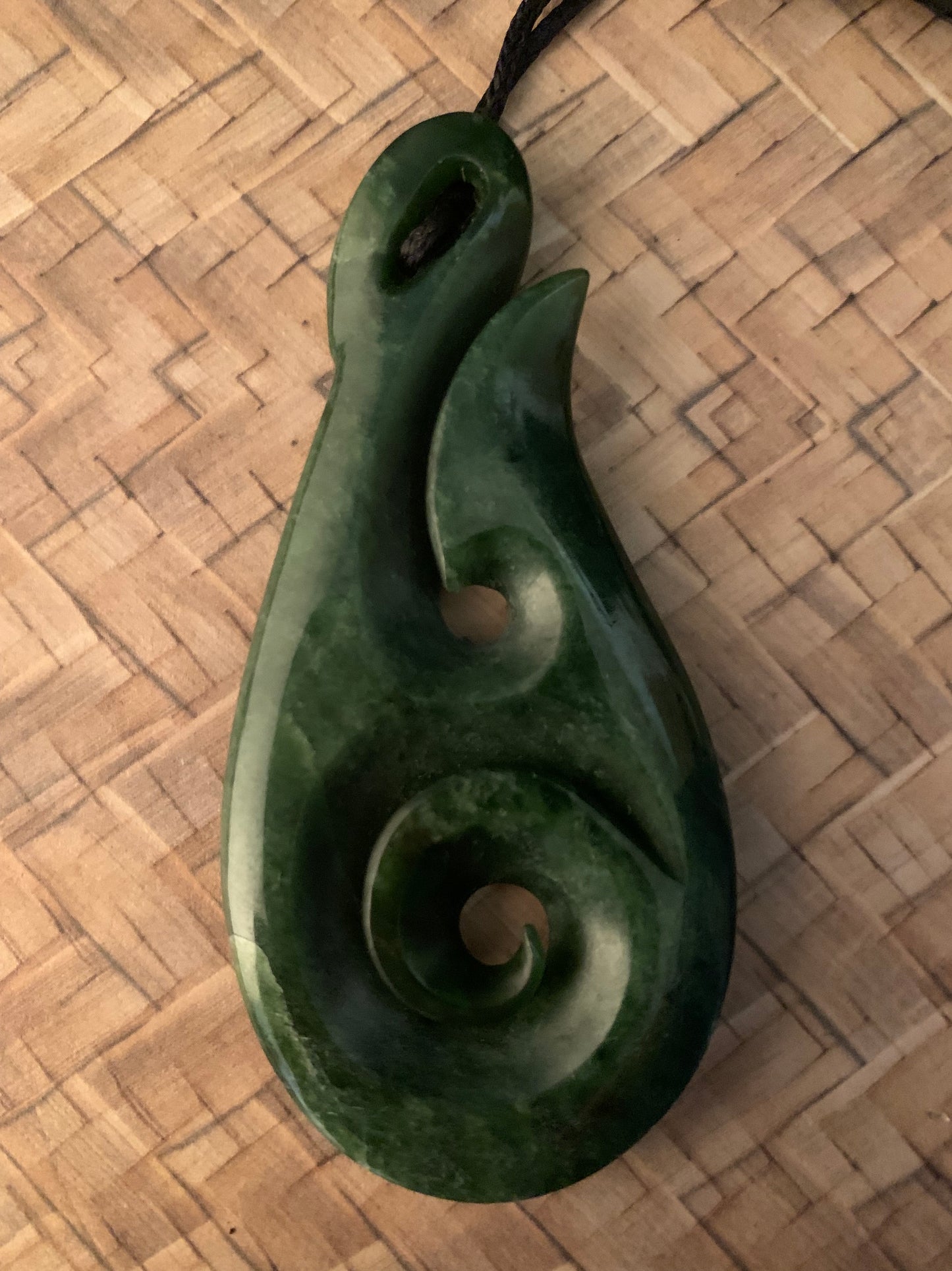 Pounamu koru he matau pendant from New Zealand available from Silver Fern Gallery