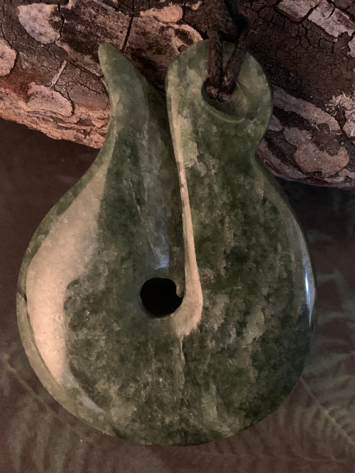 reverse side of New Zealand Maori hei matau greenstone adornment available from Silver Fern gallery