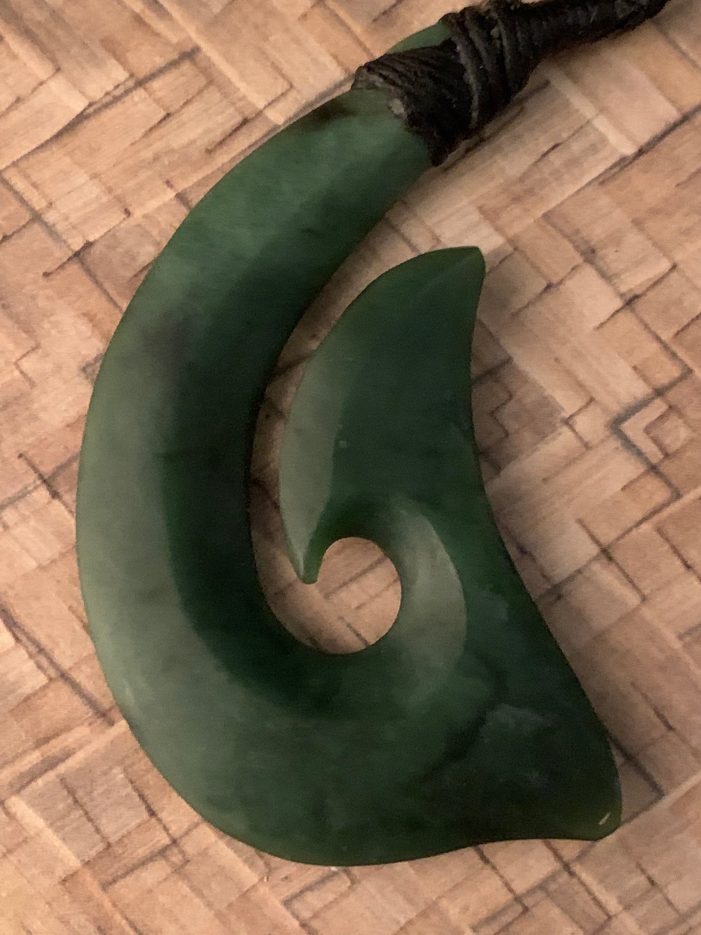 front view of Maori made hei matau fish hook from New Zealand Pounamu greenstone jade