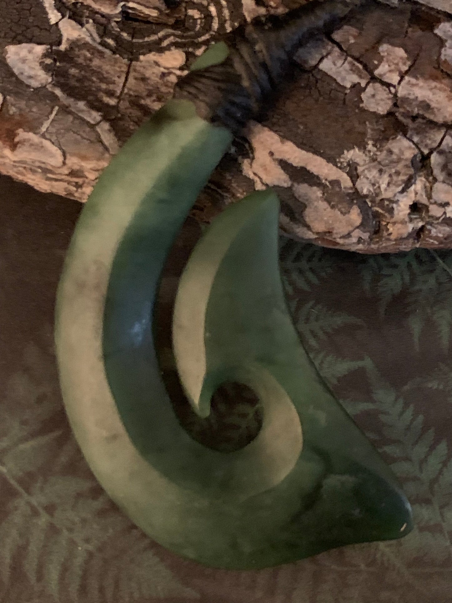 reverse side of Maori made hei matau fish hook from New Zealand Pounamu greenstone jade