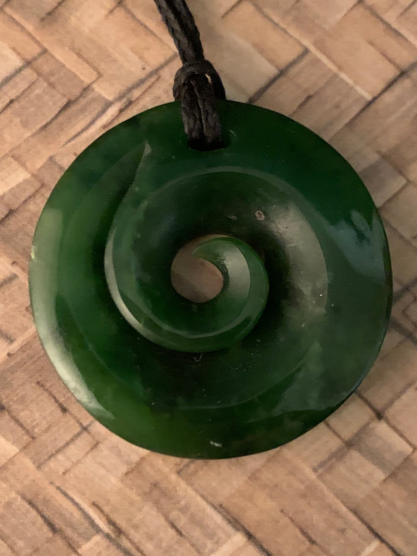 front view of Pounamu koru pendant from New Zealand available from Silver Fern Gallery