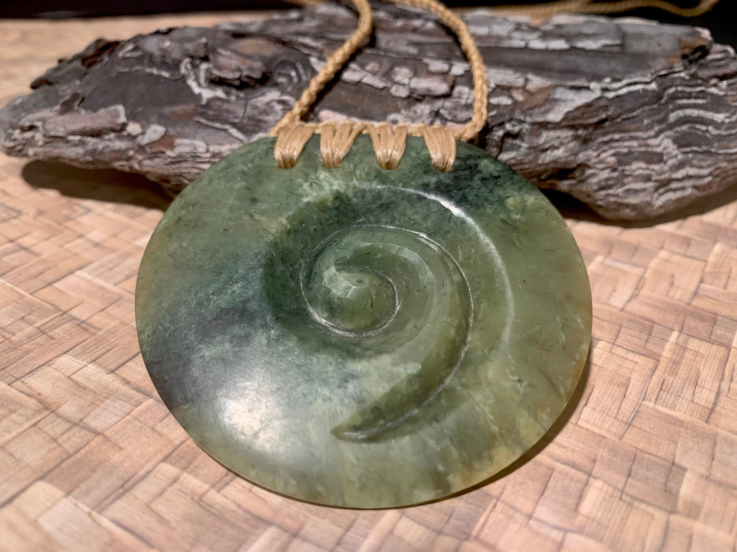 front view of Pounamu Koru Porohita disc carved by Alex Sands 62mm