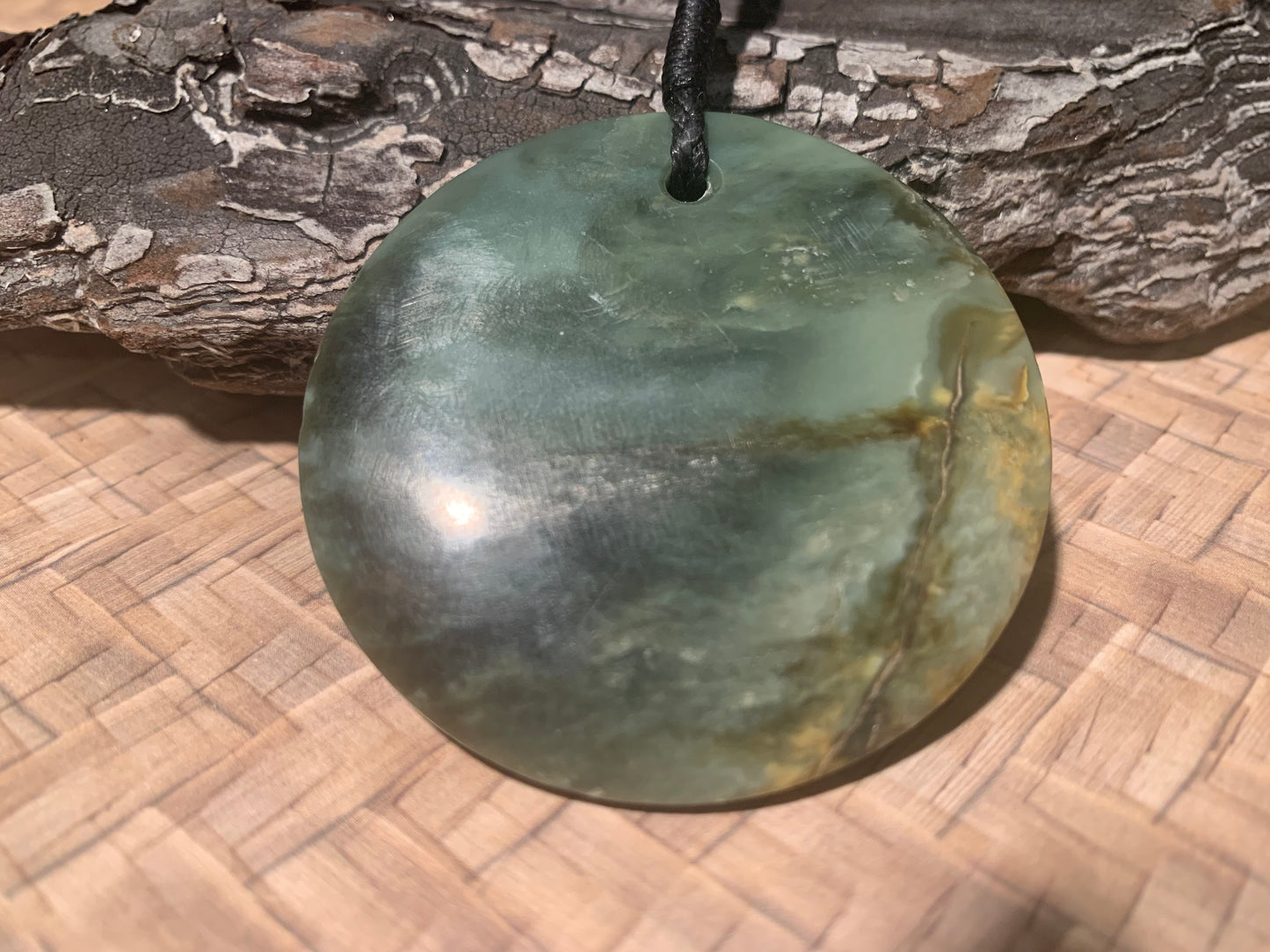 front view of Pounamu Koru Porohita disc carved by Alex Sands 50mm