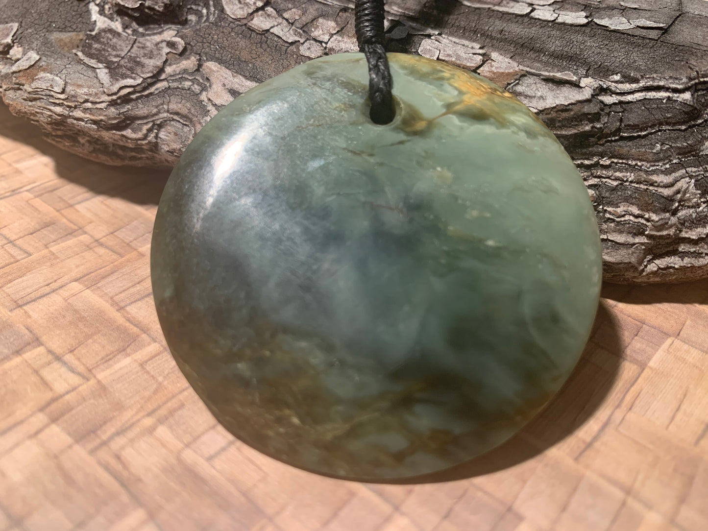 Reverse side of Pounamu Koru Porohita disc carved by Alex Sands 50mm