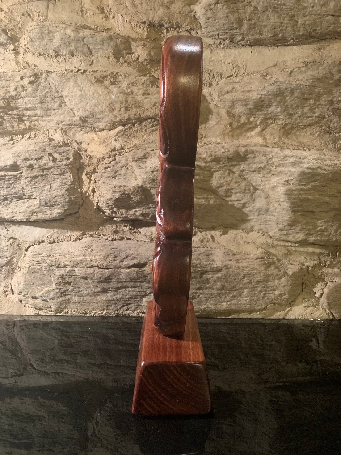 side view of Maori wood manaia on stand carved in New Zealand and available from Silver Fern Gallery