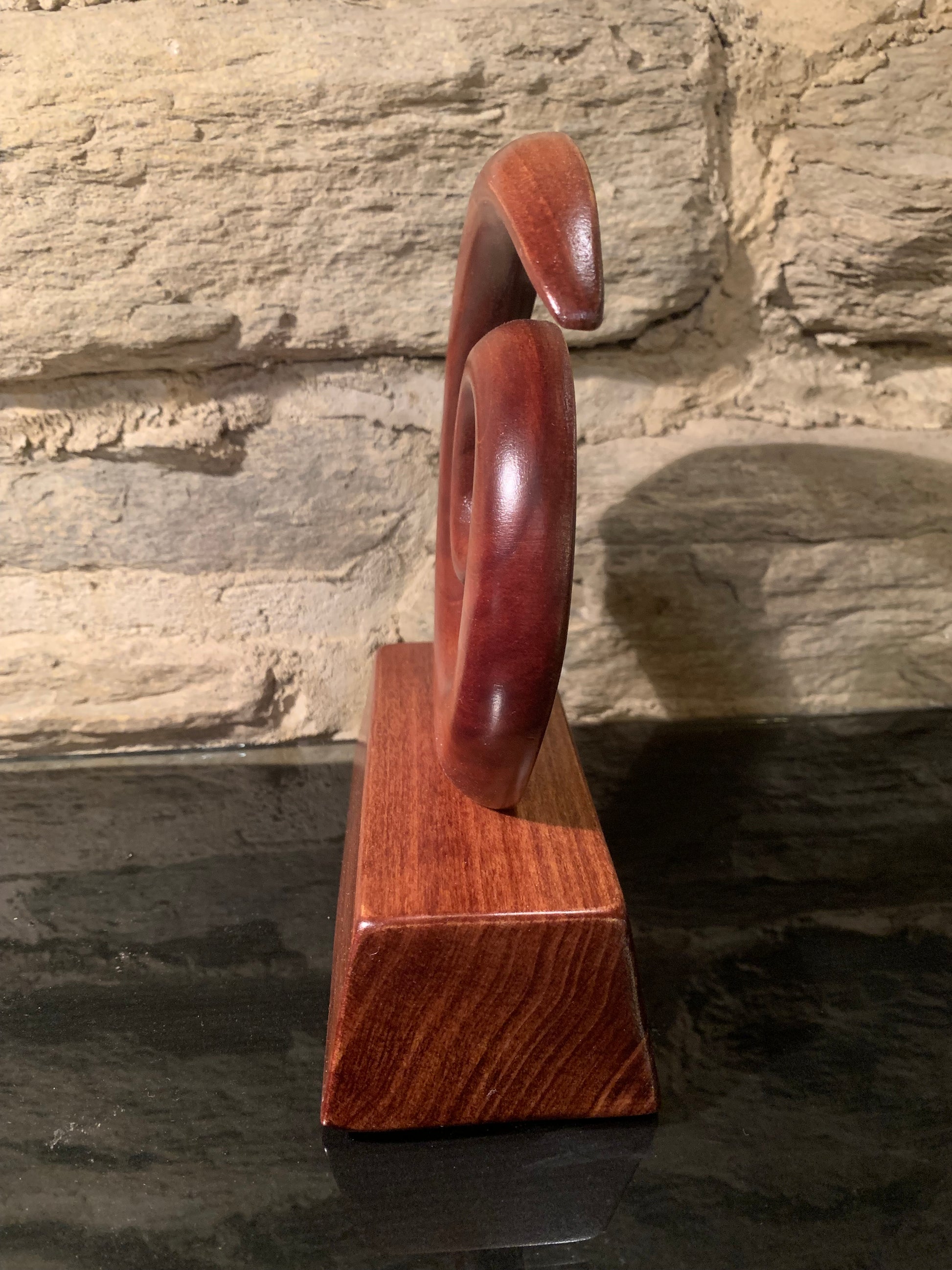 side view of Maori small koru on stand carved in New Zealand and available from Silver Fern Gallery