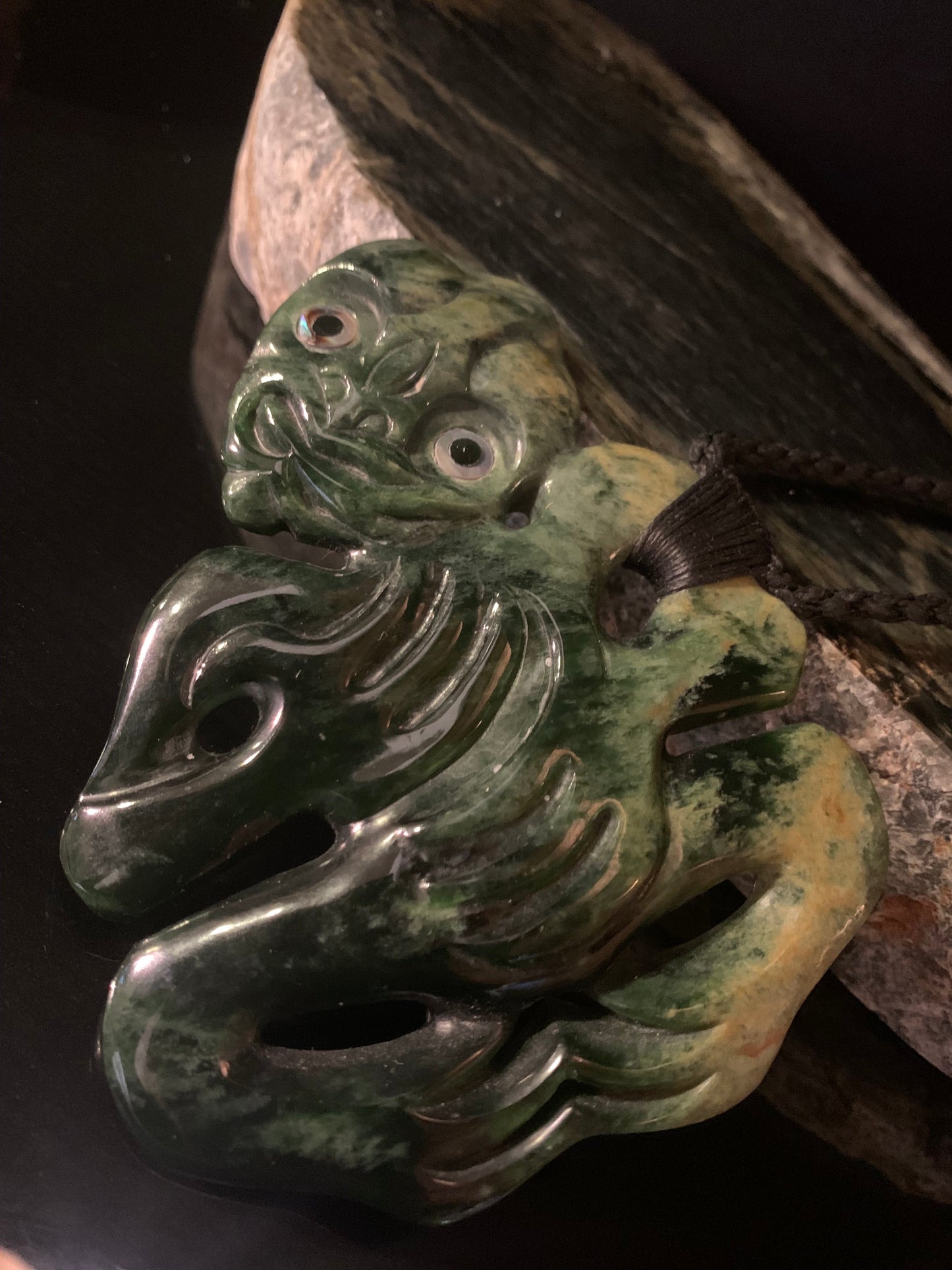 Pounamu (greenstone) tiki on a waxed nylon cord and side hung.