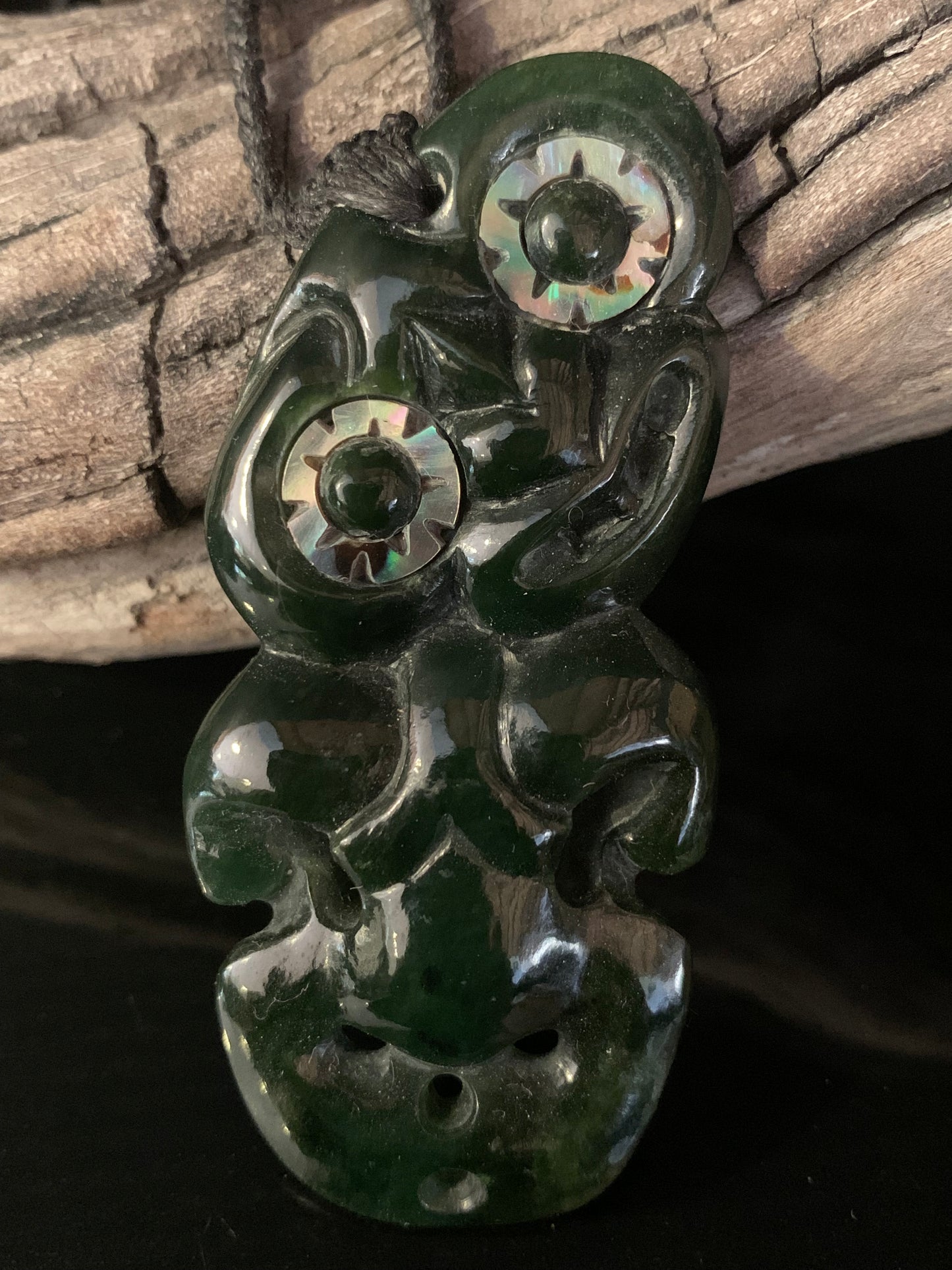 New Zealand Maori tiki pendant adornment with large paua shell eyes