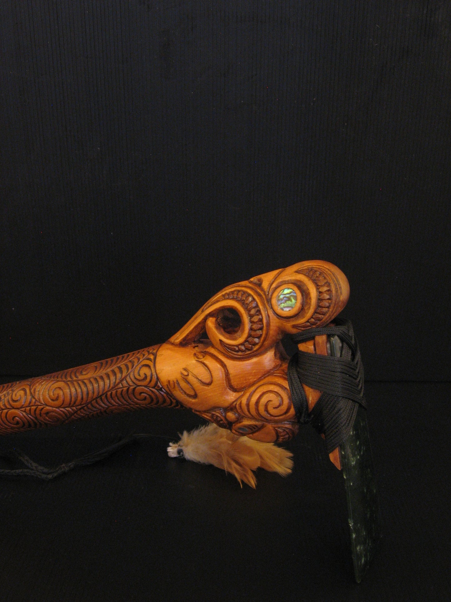 Side detail of Hand Carved Toki Poutangata on Stand by Jason Holder Silver Fern Gallery