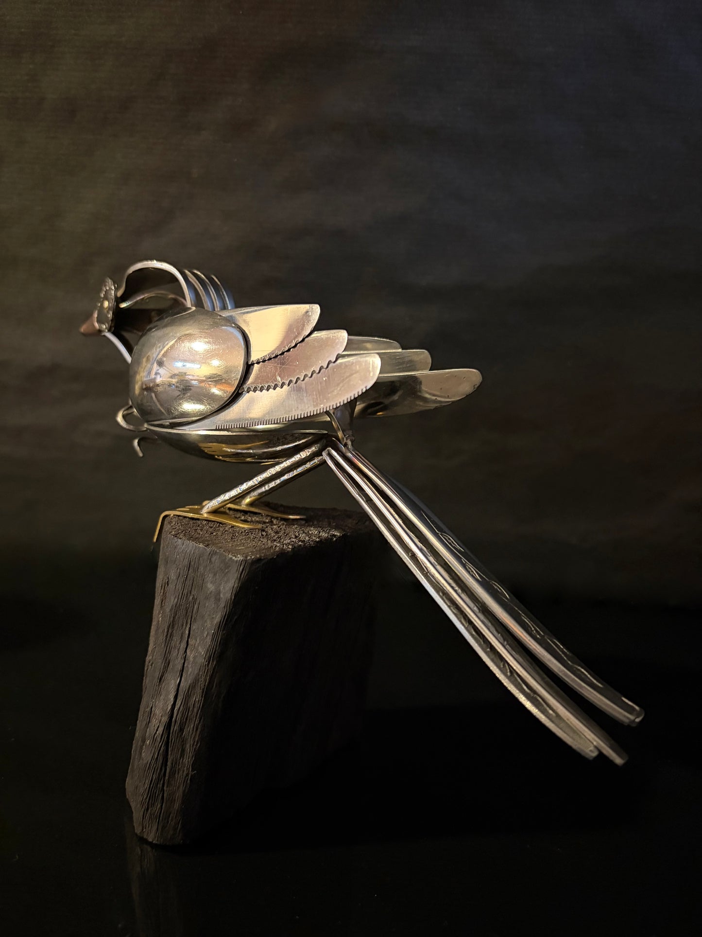 NZ tui made from cutlery showing from the back showing tail feathers. 