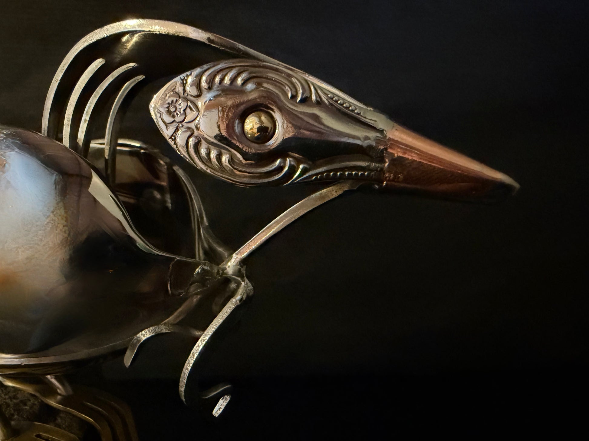 showing headshot closeup of NZ tui bird (parson bird) head cutlery sculpture.