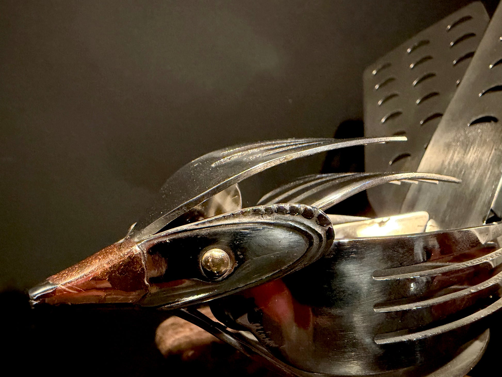 Metallic native bird sculpture (Piwakawaka).