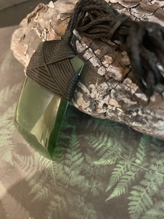 side view of Maori Pounamu hei toki adornment from New Zealand available at Silver Fern Gallery