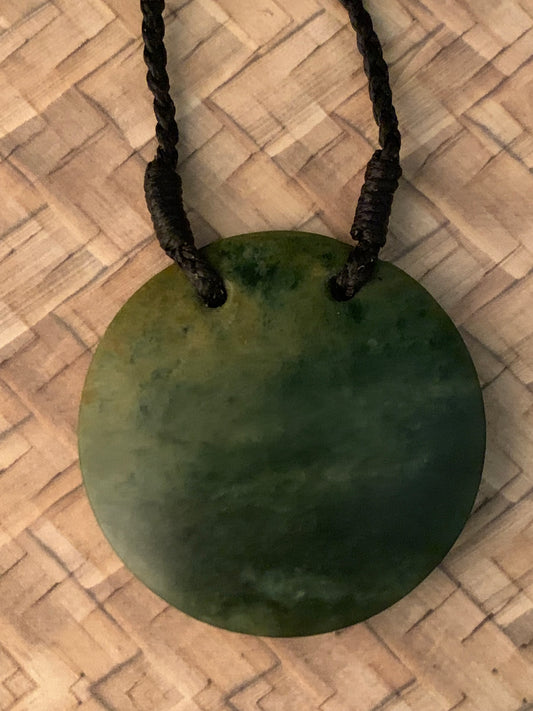 Maori Pounamu porohita disc adornment from New Zealand available at Silver Fern Gallery