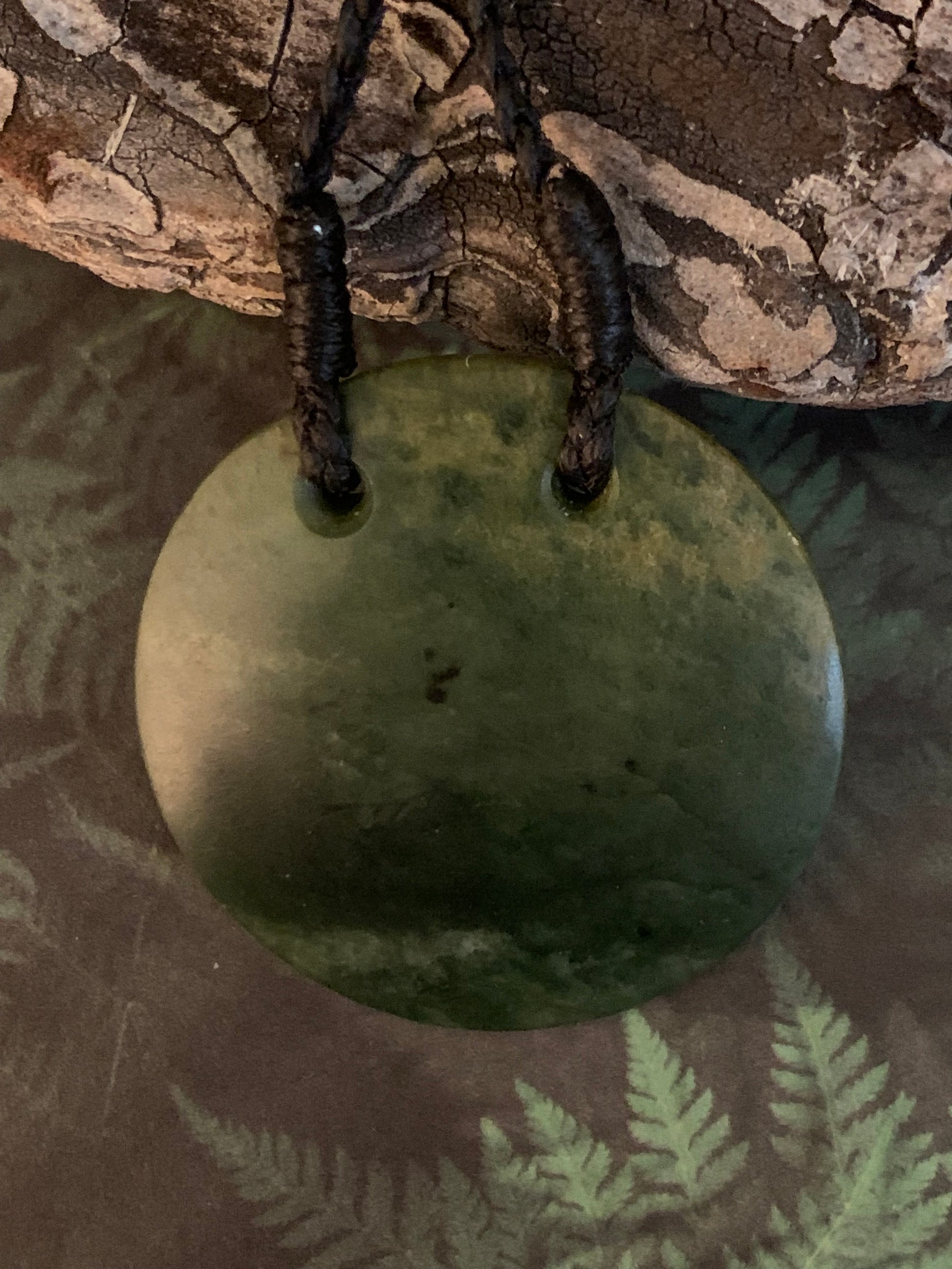 Maori Pounamu porohita disc adornment from New Zealand available at Silver Fern Gallery