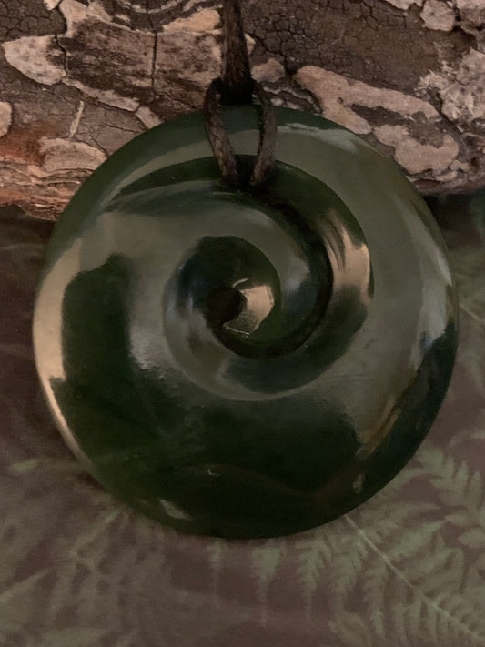 reverse side of New Zealand Maori koru spiral pounamu adornment available from Silver Fern gallery