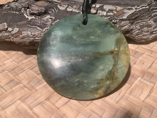 front view of Pounamu Koru Porohita disc carved by Alex Sands 50mm