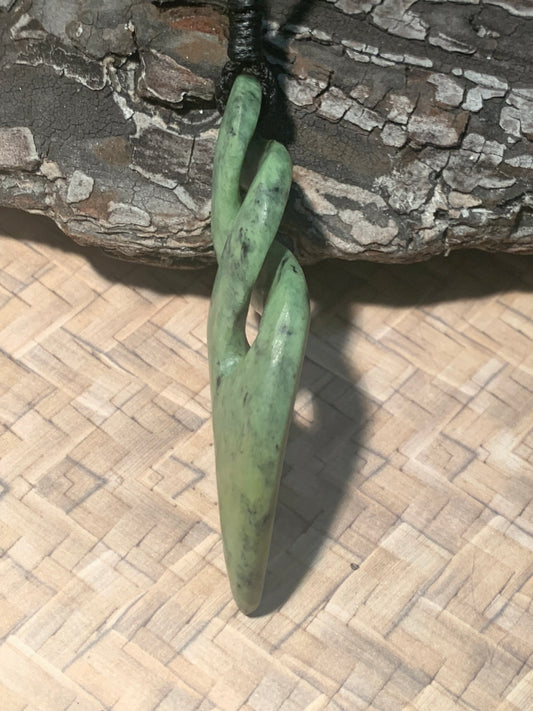 side view of Pounamu double twist 70mm made by Alex Sands
