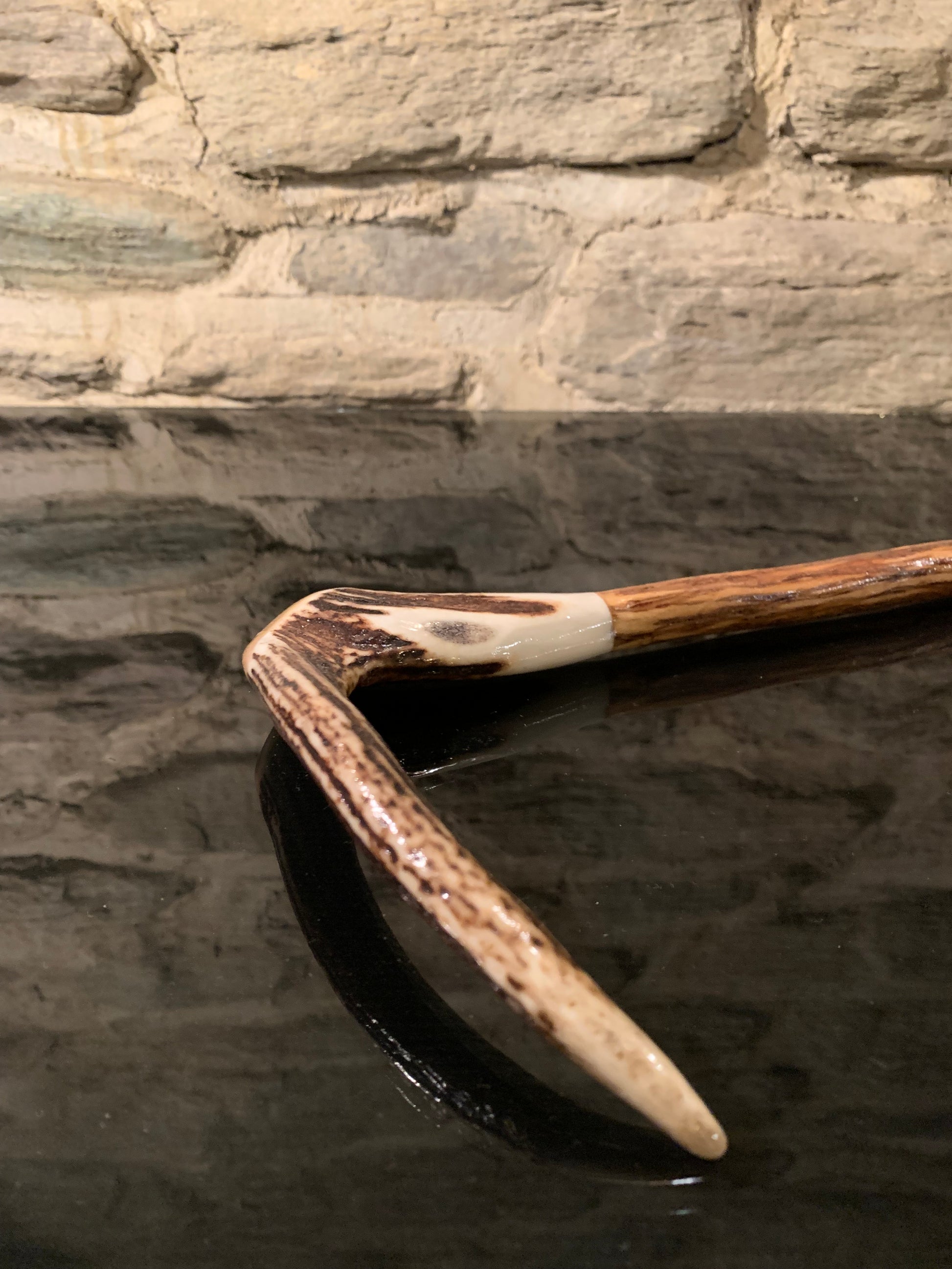 Handle of a walking stick made from deer antler and lancewood