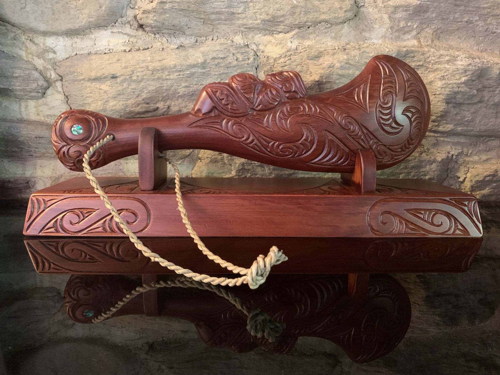 Wahaika displayed on a wooden stand 