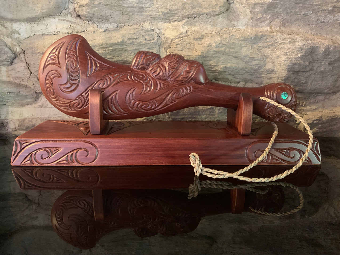 Maori wahaika sitting on a wooden stand 
