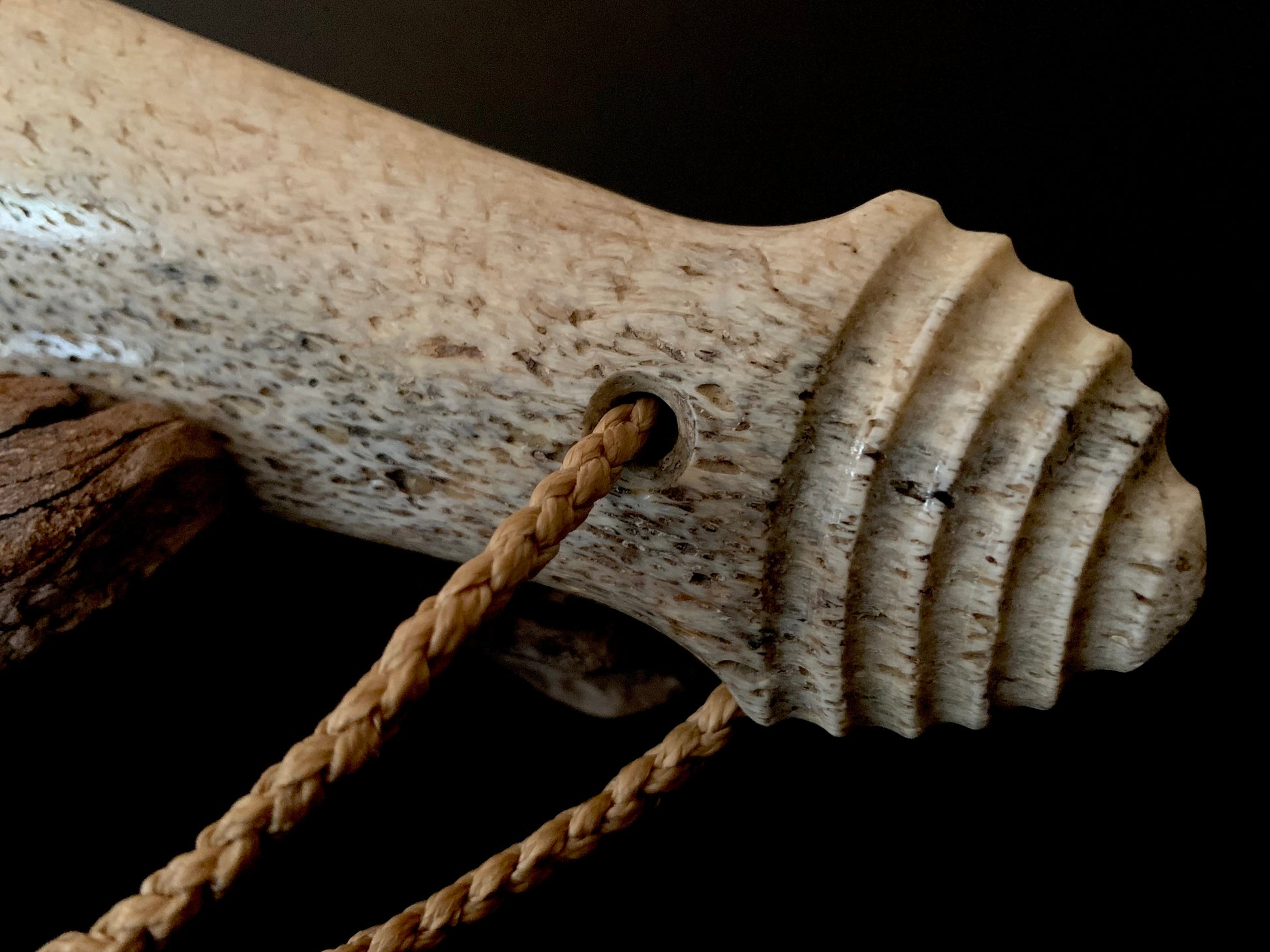 close up of maori patu weapon handle made from whale bone 