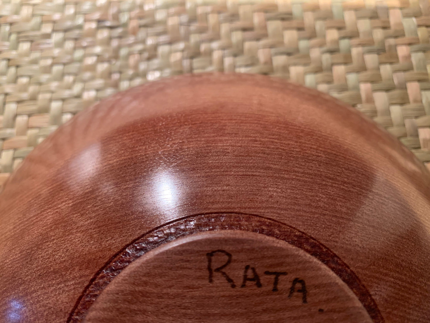 Wooden bowl base with 'RATA' engraving.