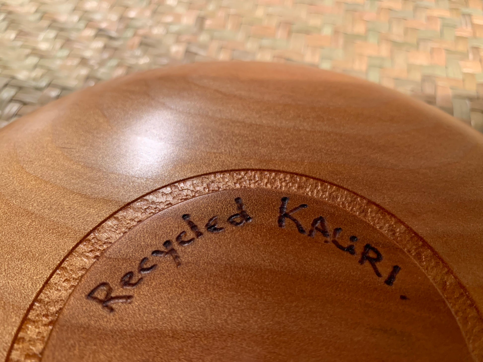 Bottom of  wooden bowl with words 'Recycled Kauri' engraved.