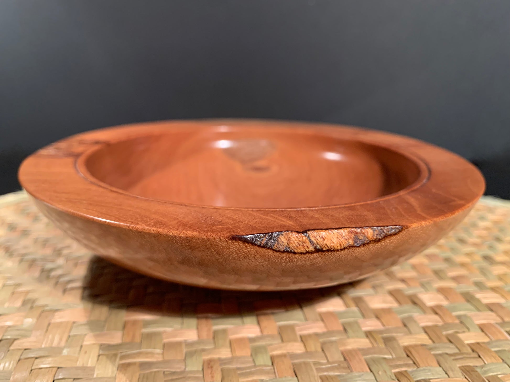 Wooden bowl with a decorative natural feature.