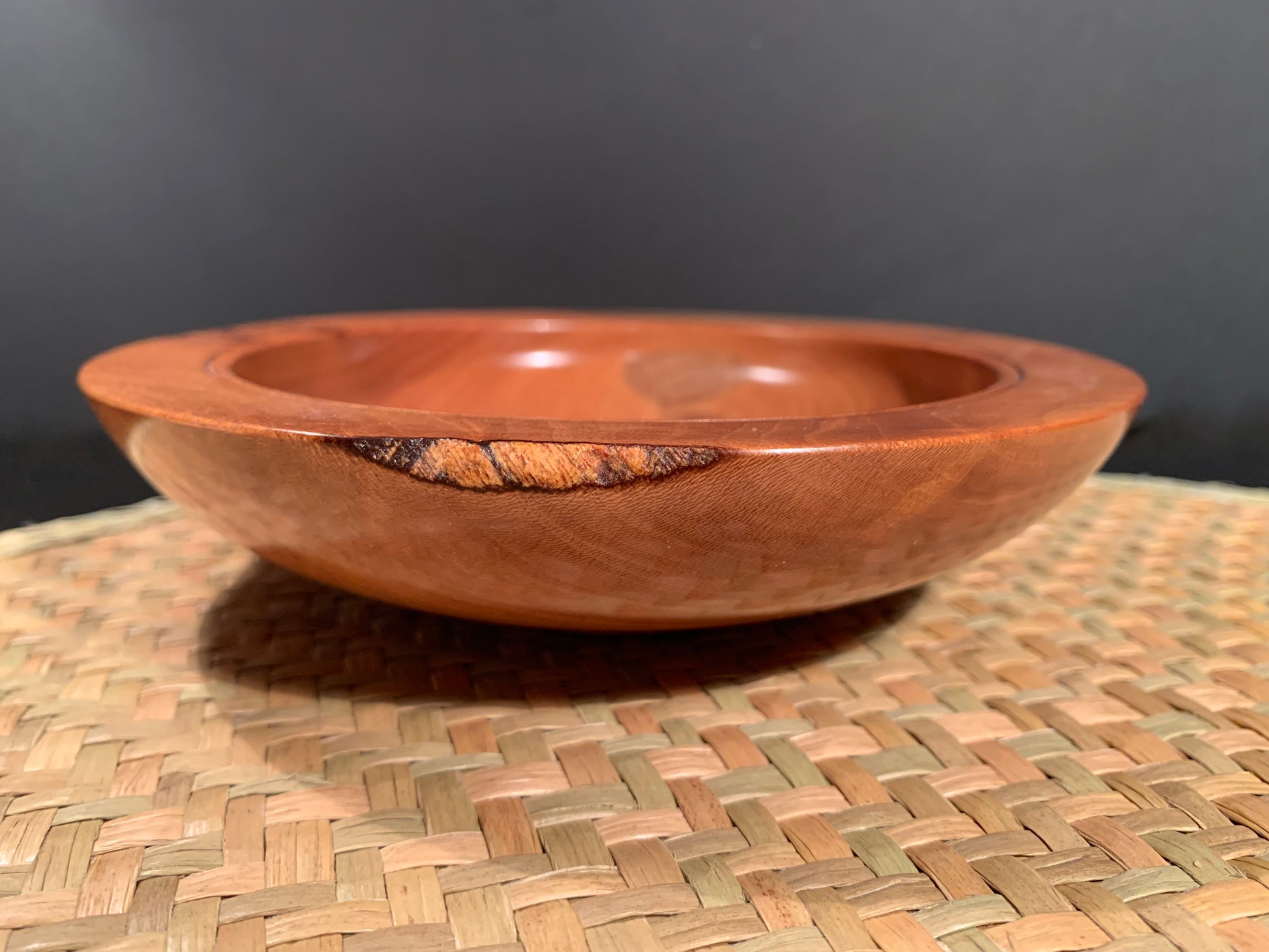 Woodturned  bowl with natural outer wood accentuated. 