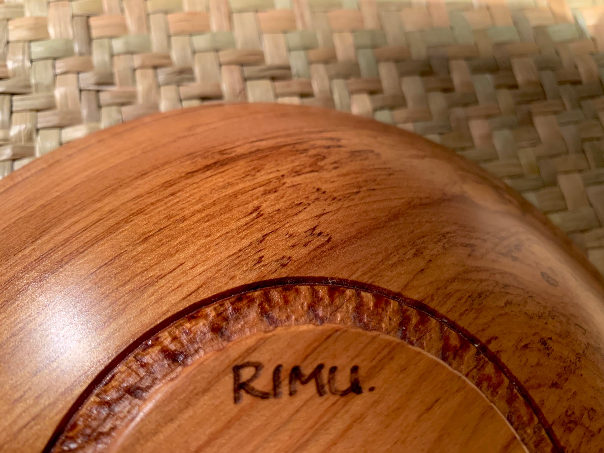 Base of wooden bowl with 'Rimu' engraving.