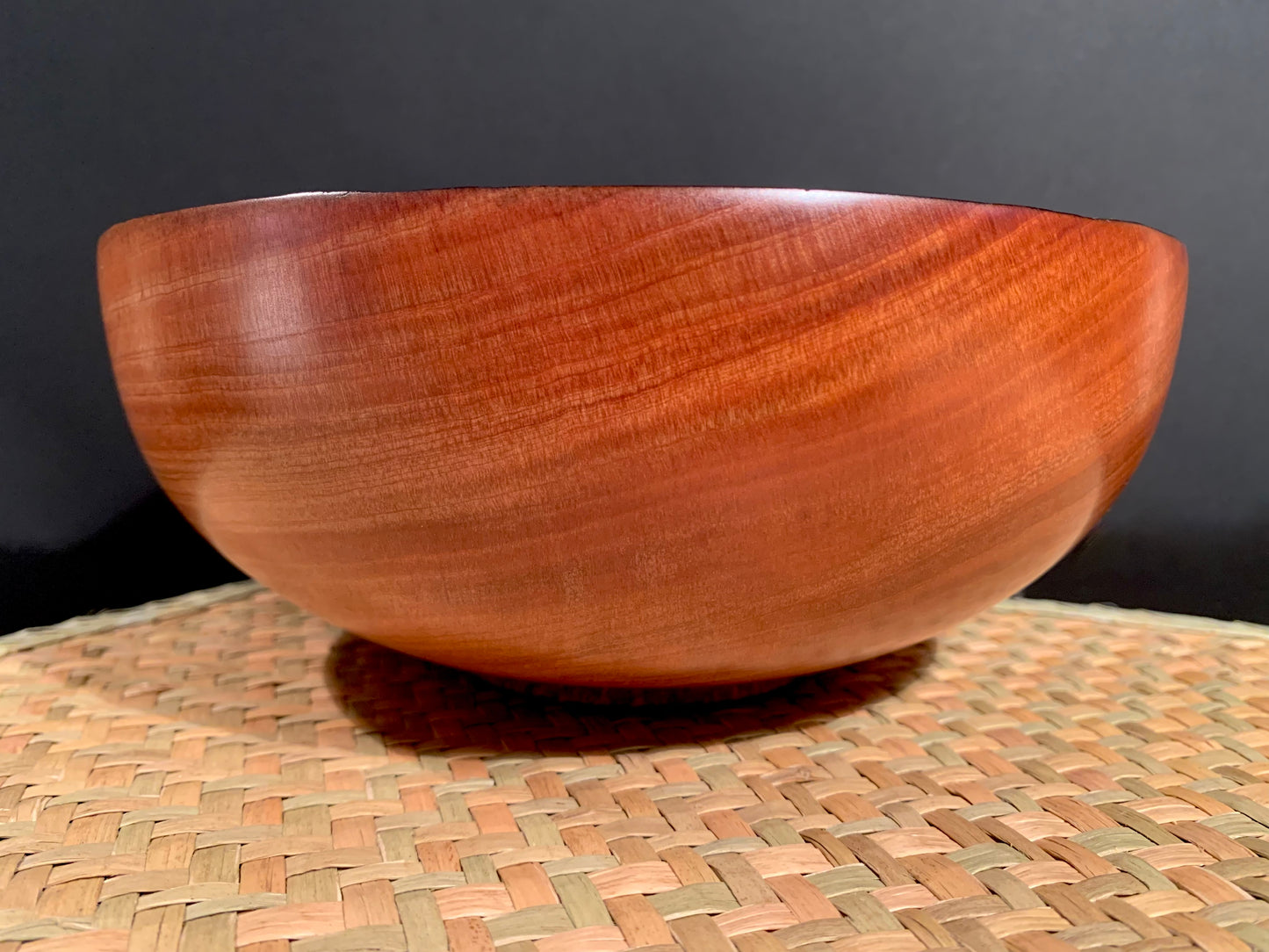 Round wooden bowl with darkened rim.