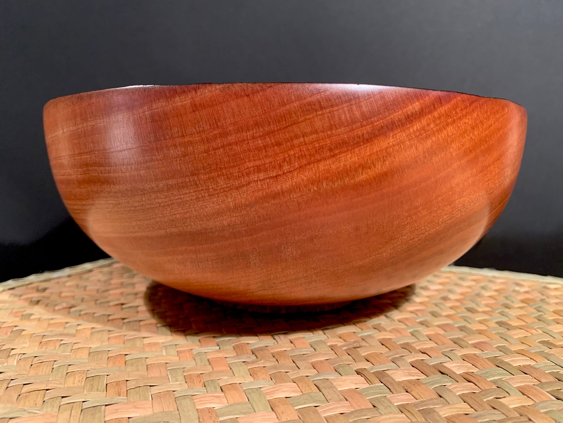 Round wooden bowl with darkened rim.