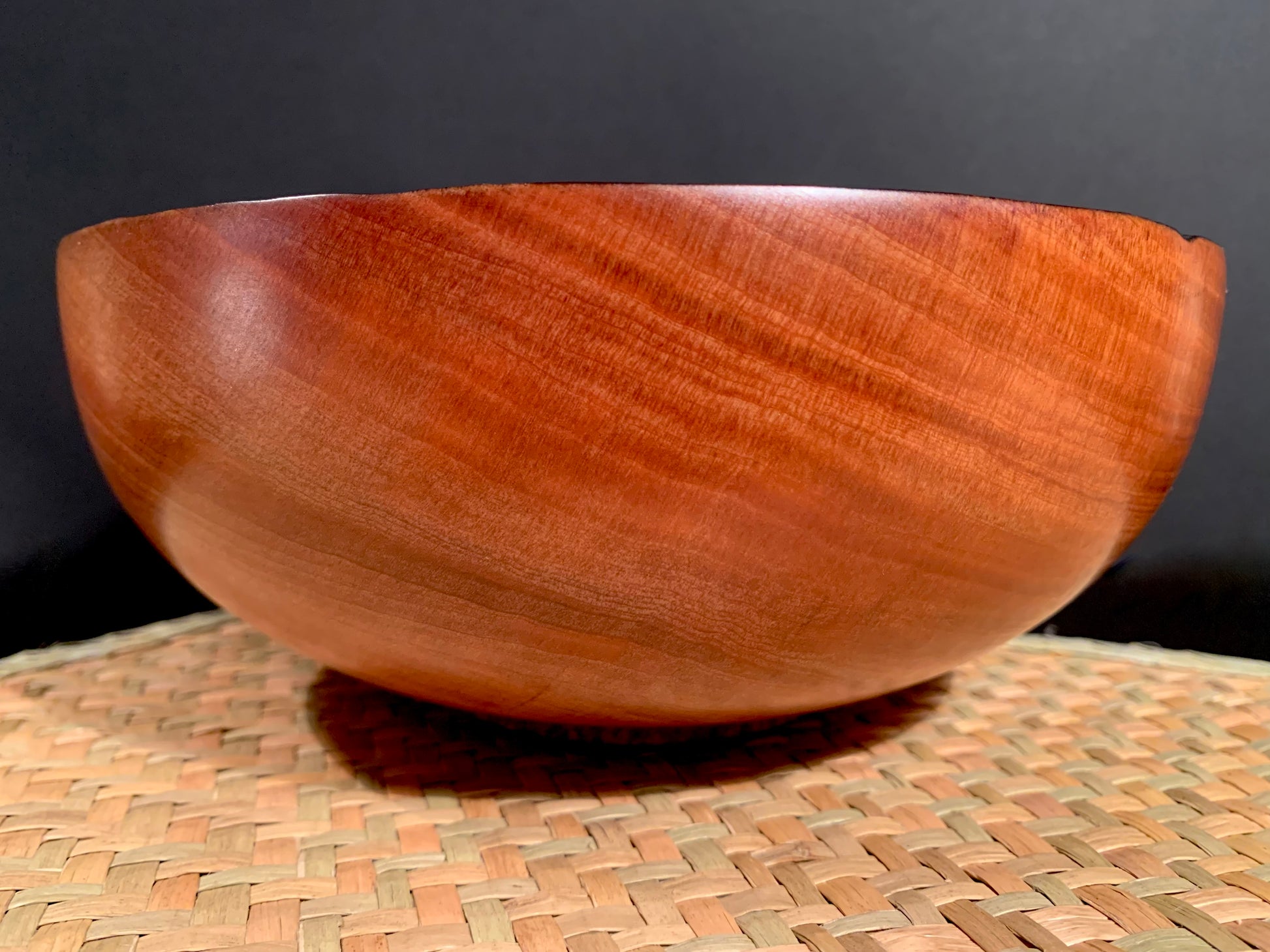 Wooden bowl with subtle linear grain detail.