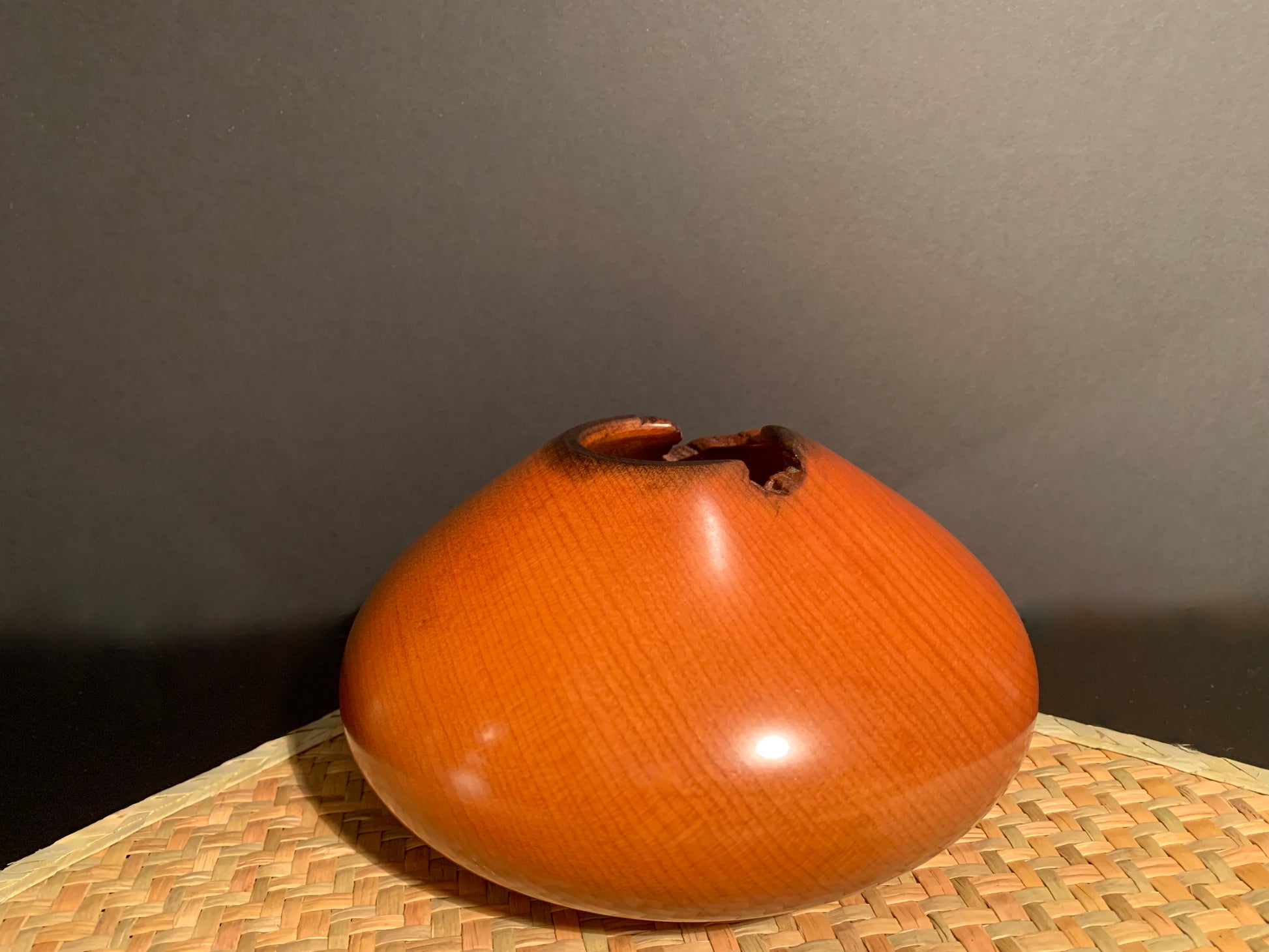 Wooden vase with a natural orifice for visual effect.