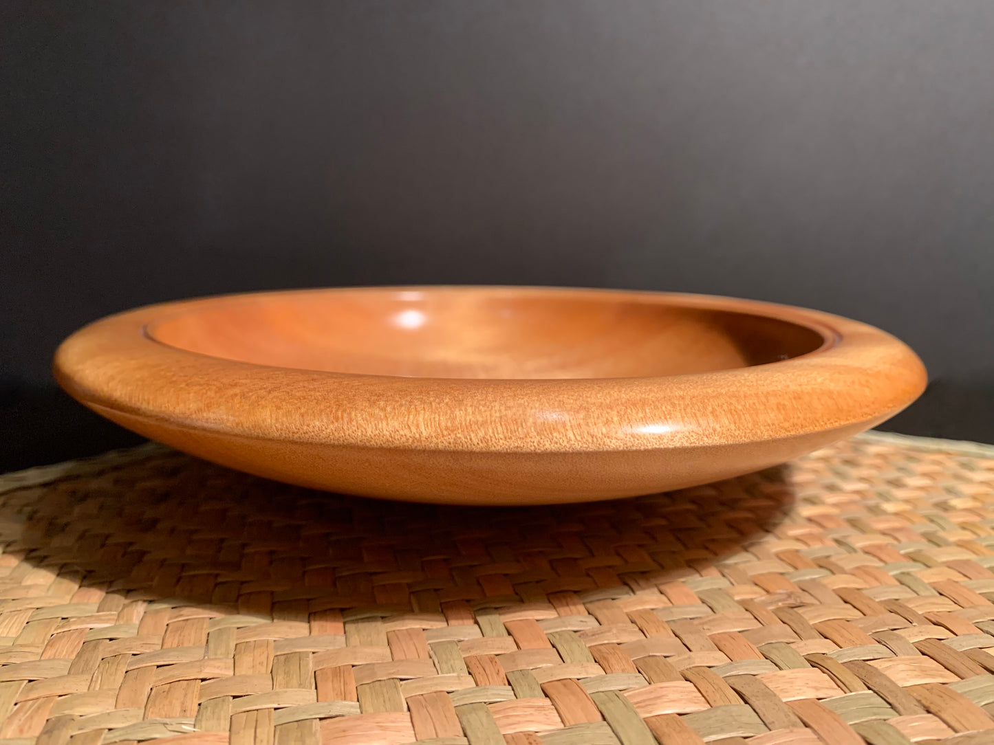Wooden bowl highlighting the gentle slope of the brim.